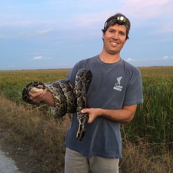 Hunter with a captured python