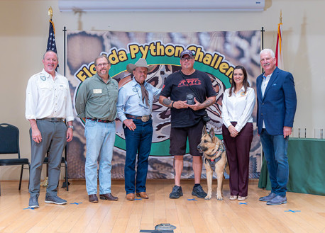 US Armed Forces veteran Jeff Lince accepts an award with his dog, Yankee.