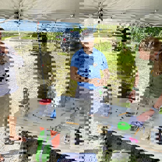 Biologists check in a python at a station